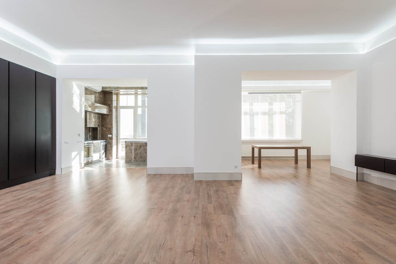 services-02 Bright and spacious empty room with wooden flooring, modern design, ideal for interior design inspiration.